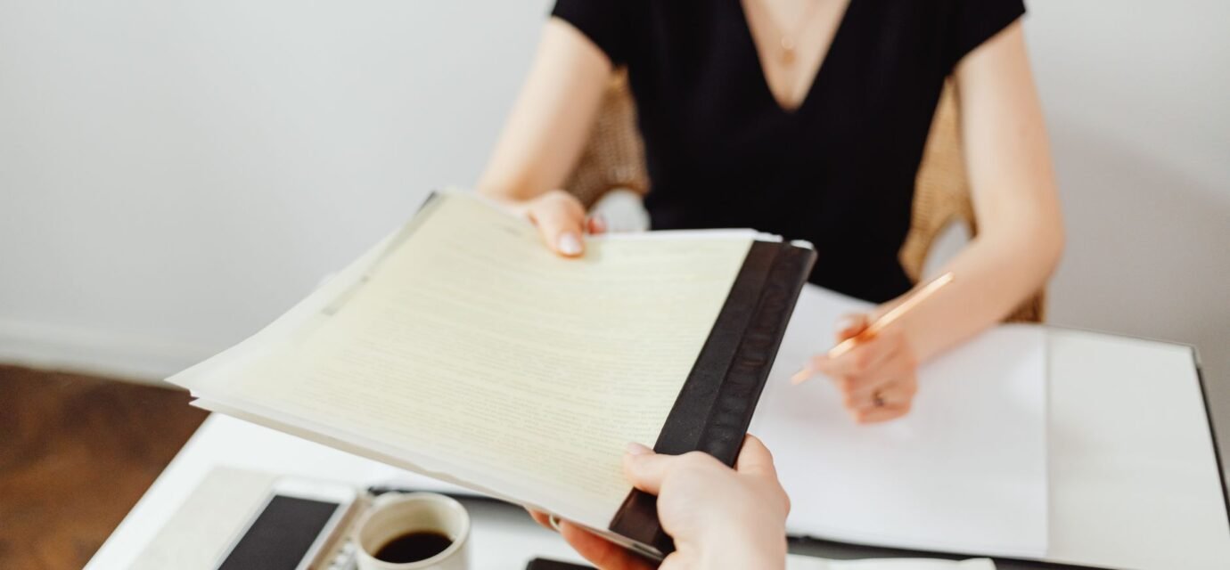 Close-up of a business document exchange at a desk