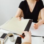 Close-up of a business document exchange at a desk