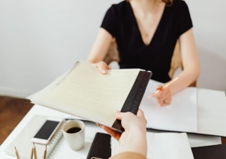 Close-up of a business document exchange at a desk