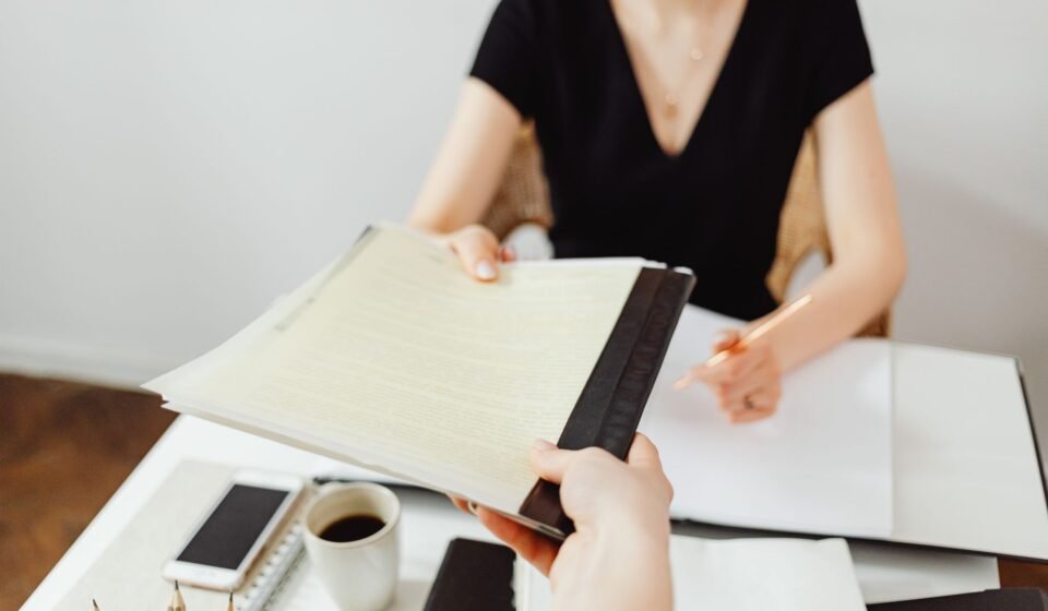 Close-up of a business document exchange at a desk